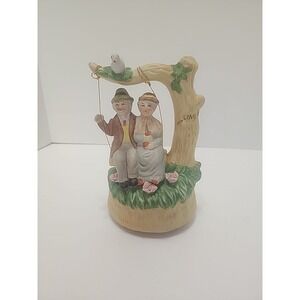 MSR Imports Inc. Porcelain Music Box Elderly Couple on Swing. Writing On Bottom